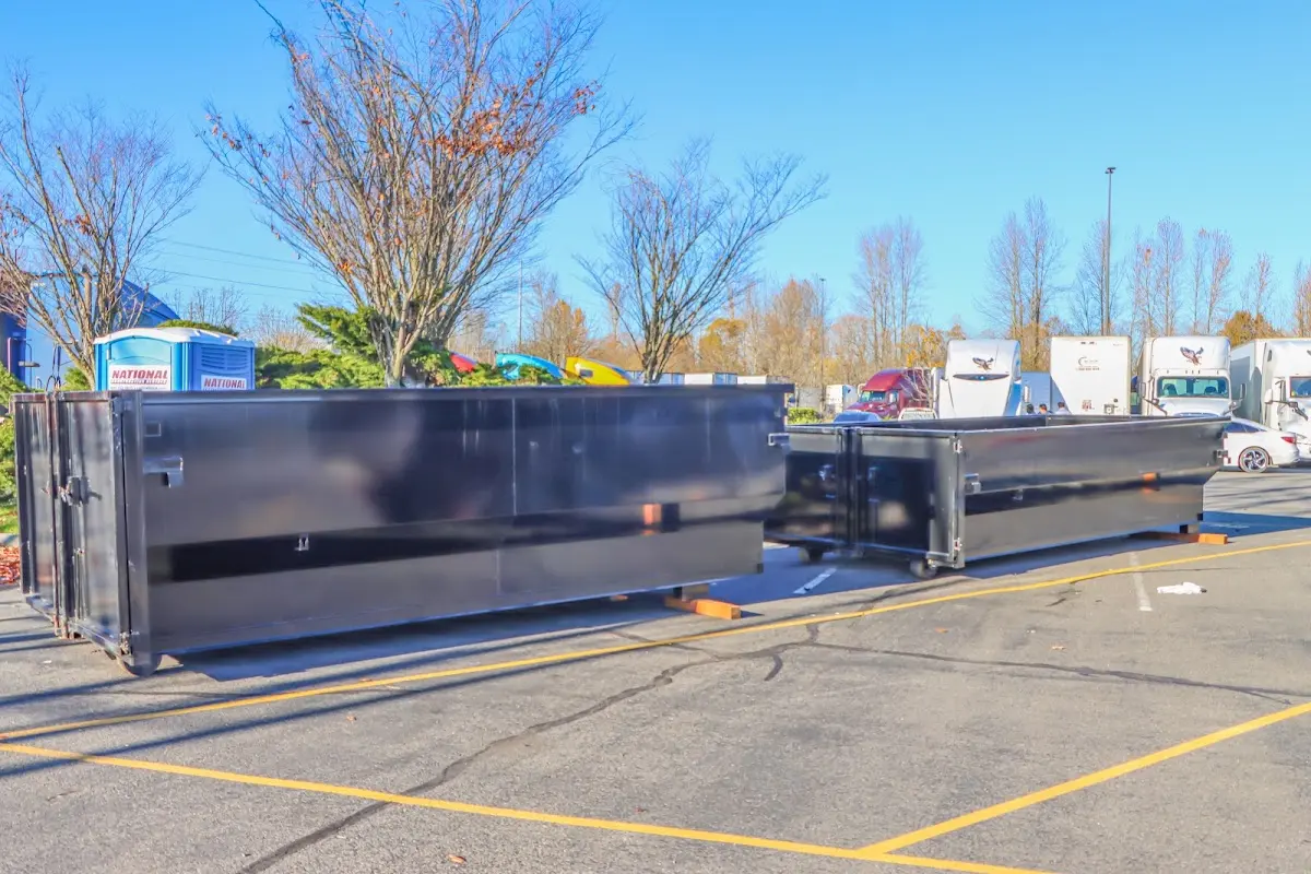 Professional dumpster rental service with roll-off container on residential driveway in Lindenhurst